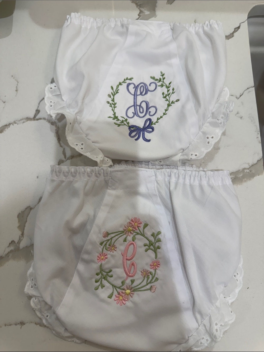 Pair of IC COLLECTIONS White Ruffle Diaper Covers w/ “C” Floral Monograms